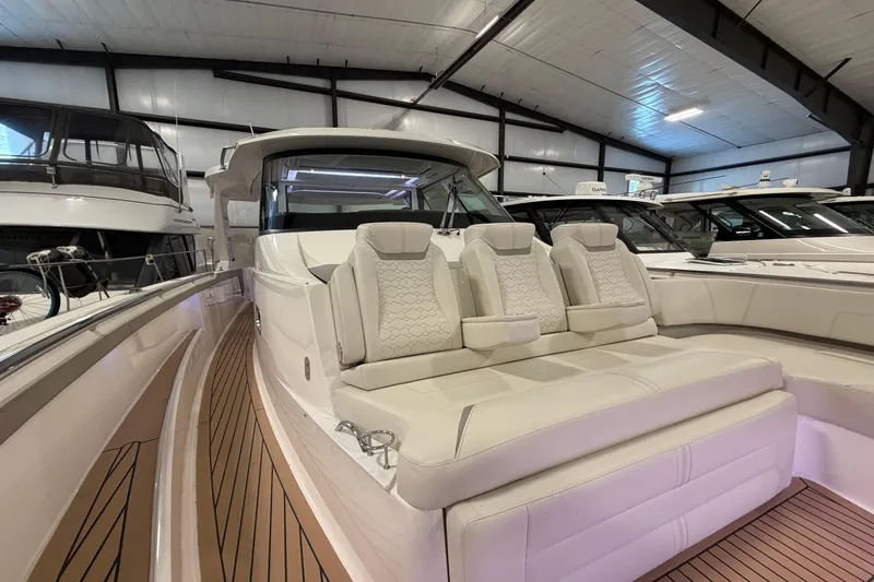 Slide: The Image of 2024 Tiara Yachts 48 LS luxury yacht interior with plush seating and sleek design. - 9