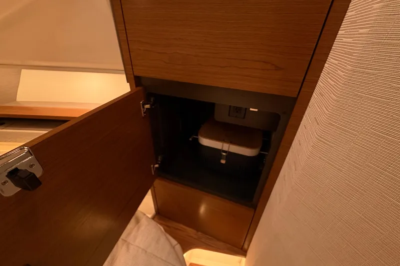 Slide: The Image of Open wooden cabinet in 2024 Tiara Yachts 48 LS interior, showcasing storage space. - 21