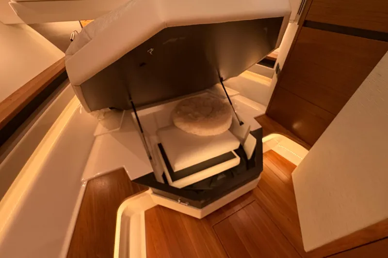 Slide: The Image of 2024 Tiara Yachts 48 LS interior with elegant wood flooring and hidden storage. - 25