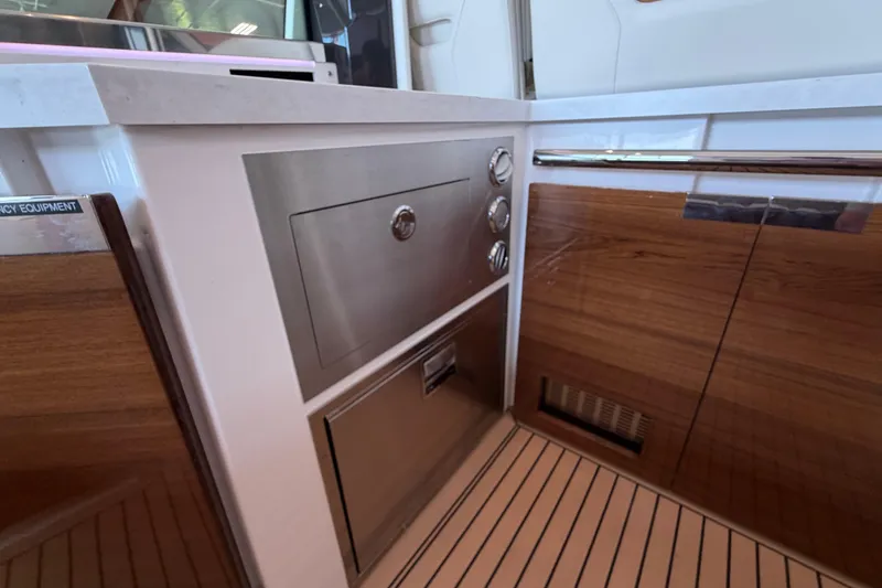 Slide: The Image of 2024 Tiara Yachts 48 LS interior with sleek cabinetry and modern appliances. - 36