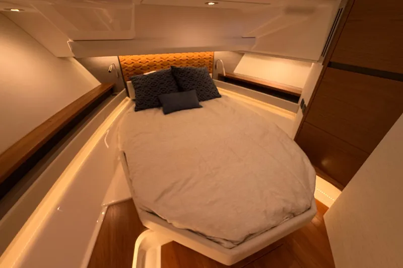 Slide: The Image of Luxurious cabin interior of 2024 Tiara Yachts 48 LS with cozy bedding and ambient lighting. - 24