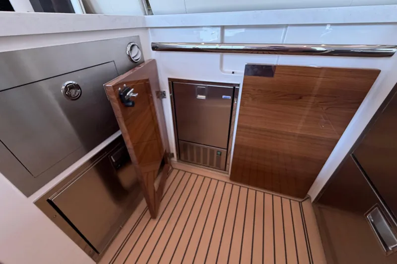 Slide: The Image of 2024 Tiara Yachts 48 LS interior with sleek cabinetry and stainless steel appliances. - 37