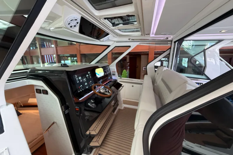 Slide: The Image of 2024 Tiara Yachts 48 LS interior with modern helm, luxurious seating, and advanced navigation systems. - 32