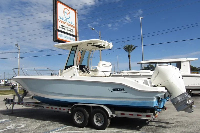 Slide: The Image of 2023 Boston Whaler 280 Dauntless boat on trailer at Nautical Ventures dealership. - 1
