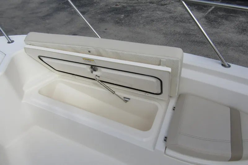Slide: The Image of 2023 Boston Whaler 280 Dauntless boat storage compartment with cushioned seating. - 10
