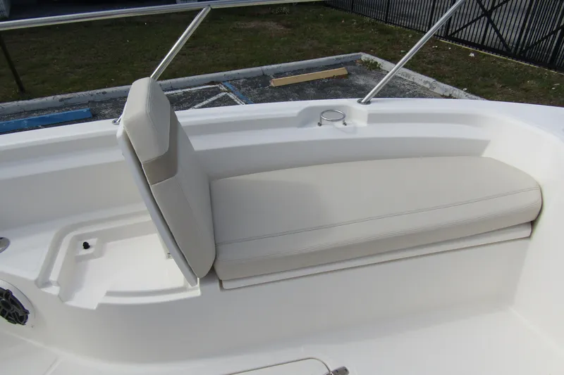 Slide: The Image of 2023 Boston Whaler 280 Dauntless boat seating area with cushioned bench and backrest. - 11