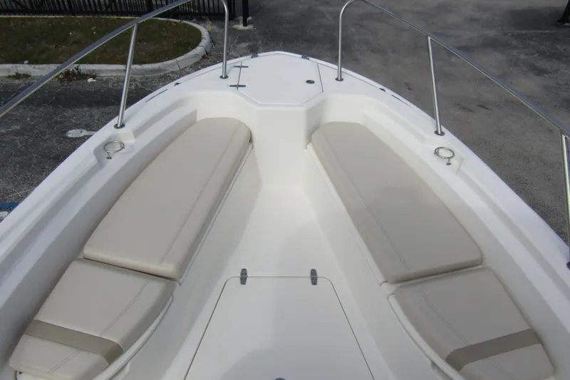 Slide: The Image of 2023 Boston Whaler 280 Dauntless boat interior with cushioned seating and stainless steel railings. - 12