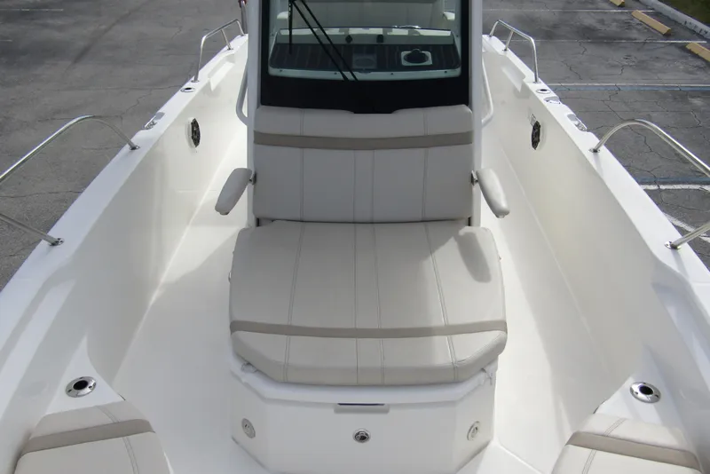 Slide: The Image of 2023 Boston Whaler 280 Dauntless boat interior with cushioned seating and armrests. - 13