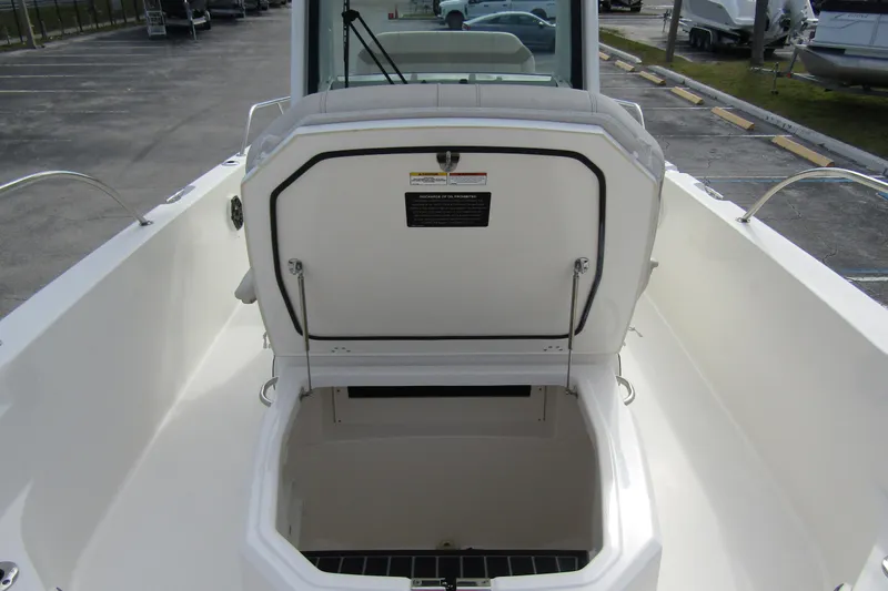 Slide: The Image of 2023 Boston Whaler 280 Dauntless boat storage compartment open, showcasing spacious interior. - 14
