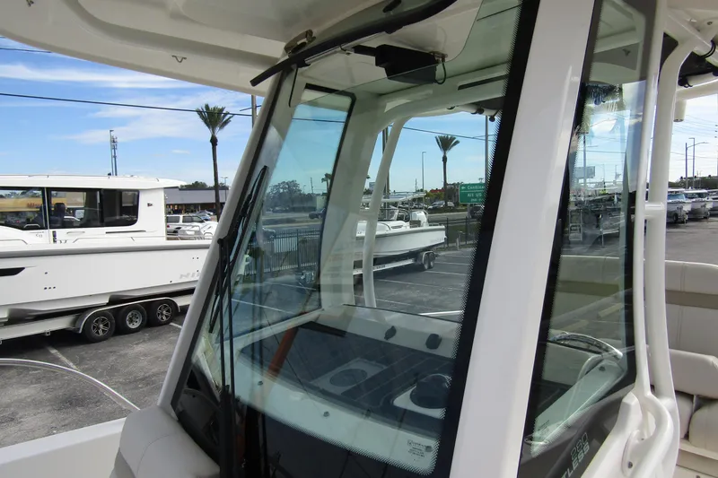 Slide: The Image of 2023 Boston Whaler 280 Dauntless boat interior with windshield and console view. - 16