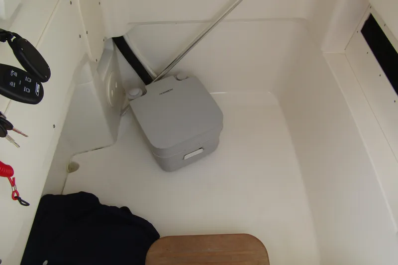 Slide: The Image of Interior of 2023 Boston Whaler 280 Dauntless with portable toilet and control panel. - 20