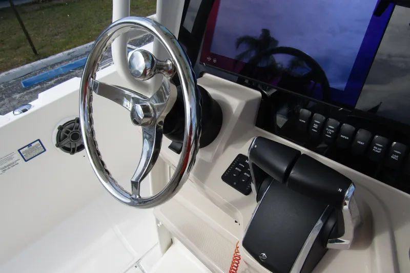 Slide: The Image of 2023 Boston Whaler 280 Dauntless boat helm with steering wheel and controls. - 24