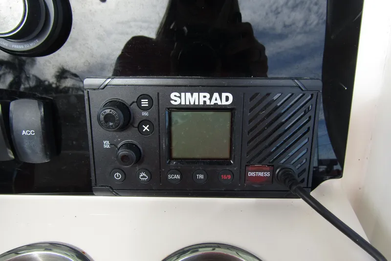 Slide: The Image of Simrad marine radio on 2023 Boston Whaler 280 Dauntless dashboard. - 27