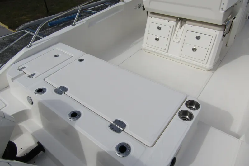 Slide: The Image of 2023 Boston Whaler 280 Dauntless interior with storage compartments and cup holders. - 29