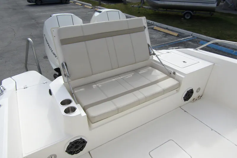 Slide: The Image of 2023 Boston Whaler 280 Dauntless boat seating area with cup holders and speakers. - 30