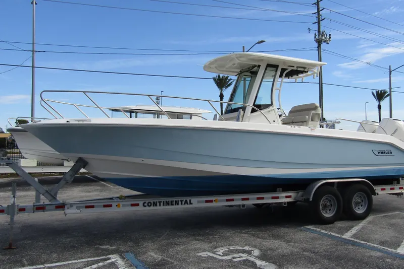 Slide: The Image of 2023 Boston Whaler 280 Dauntless boat on trailer, parked outdoors. - 6