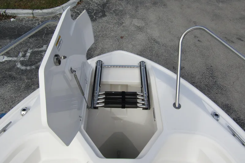 Slide: The Image of 2023 Boston Whaler 280 Dauntless bow storage with ladder and open hatch. - 8
