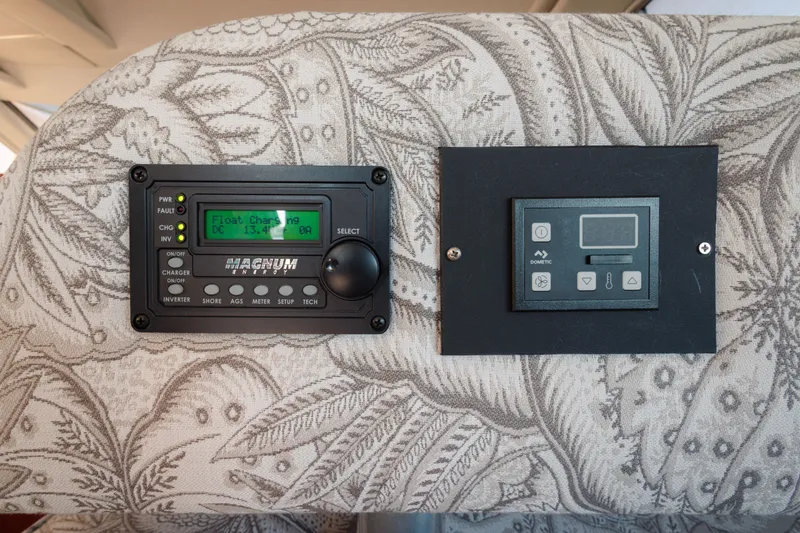 Slide: The Image of Control panels on a 1997 Maxum 4600 SCB boat, featuring Magnum Energy and Dometic displays. - 17