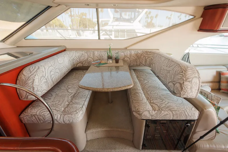Slide: The Image of 1997 Maxum 4600 SCB yacht interior with patterned seating and a central table. - 18