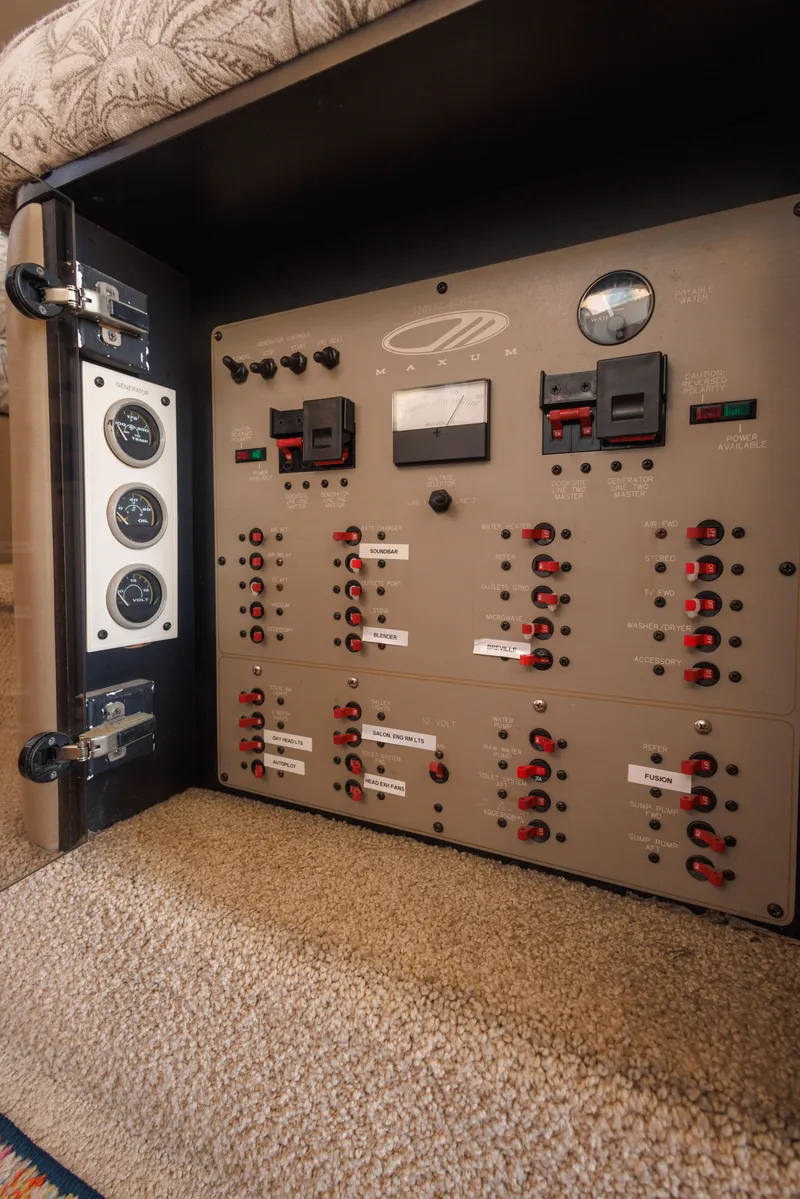 Slide: The Image of Electrical control panel inside a 1997 Maxum 4600 SCB yacht, featuring switches and gauges. - 19