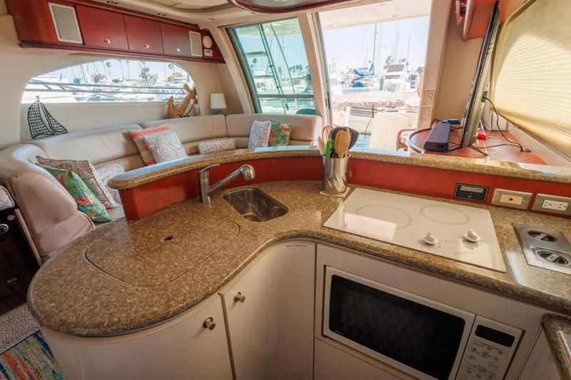 Slide: The Image of Luxurious 1997 Maxum 4600 SCB yacht interior with modern kitchen and cozy seating area. - 21