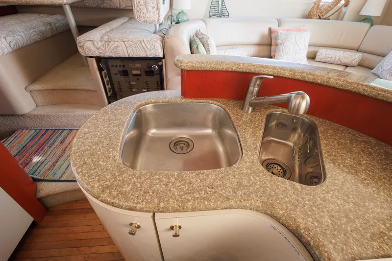 Slide: The Image of 1997 Maxum 4600 SCB yacht interior with dual sinks and cozy seating area. - 22