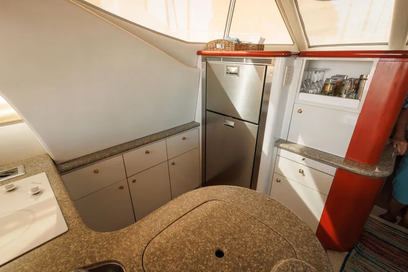 Slide: The Image of Interior of 1997 Maxum 4600 SCB yacht kitchen with modern appliances and storage cabinets. - 23