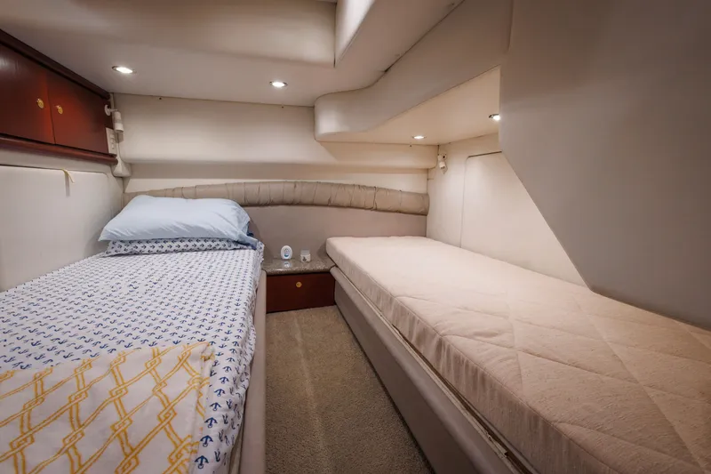 Slide: The Image of 1997 Maxum 4600 SCB yacht cabin with twin beds, cozy lighting, and elegant decor. - 27