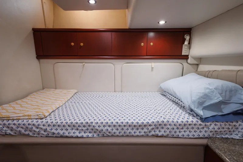 Slide: The Image of Cozy cabin bed in 1997 Maxum 4600 SCB yacht with anchor-patterned sheets. - 29