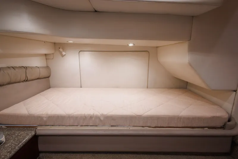 Slide: The Image of Interior cabin of 1997 Maxum 4600 SCB yacht with beige bedding and soft lighting. - 30