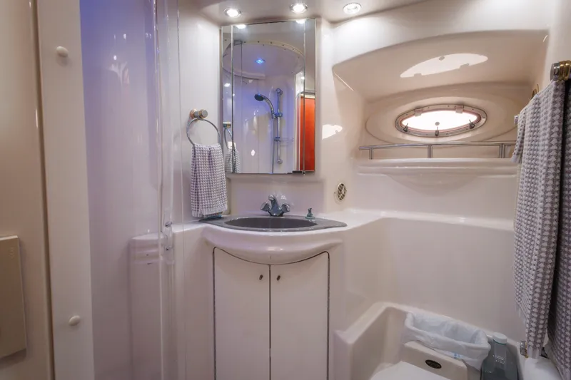 Slide: The Image of Luxurious bathroom in 1997 Maxum 4600 SCB yacht with modern fixtures and porthole window. - 31