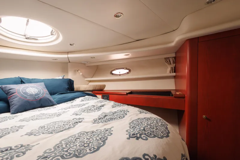 Slide: The Image of Luxurious cabin interior of 1997 Maxum 4600 SCB yacht with elegant bedding and wood accents. - 37