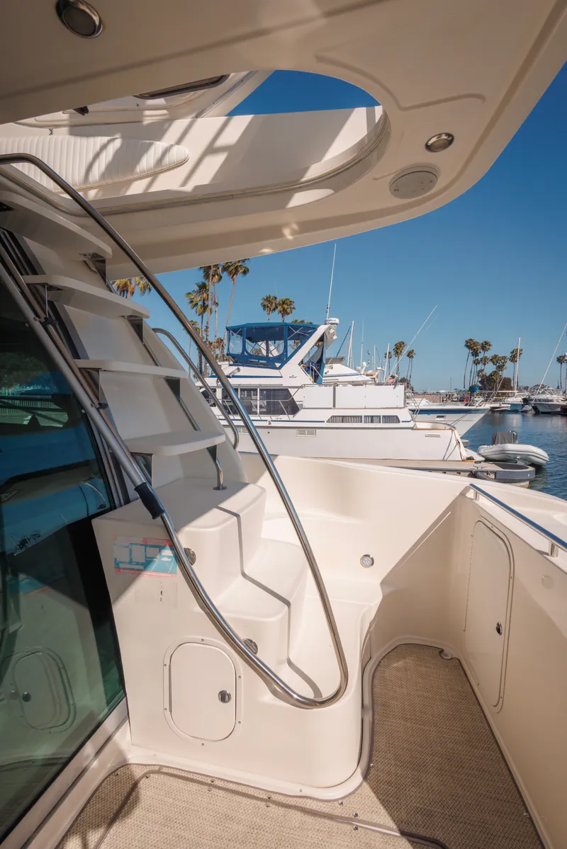 Slide: The Image of 1997 Maxum 4600 SCB yacht docked at marina, featuring sleek design and spacious deck. - 41