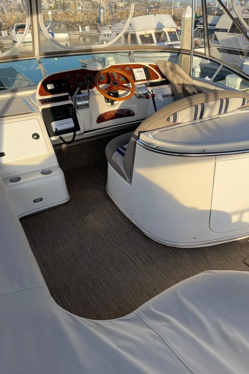 Slide: The Image of 1997 Maxum 4600 SCB yacht cockpit with steering wheel and control panel. - 43