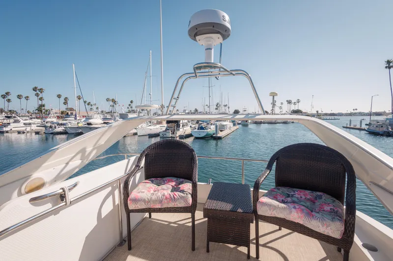 Slide: The Image of 1997 Maxum 4600 SCB yacht deck with chairs, overlooking marina and sailboats. - 46