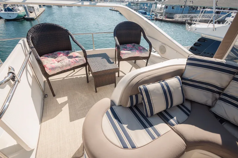 Slide: The Image of Luxurious seating area on 1997 Maxum 4600 SCB yacht with striped cushions and wicker chairs. - 47