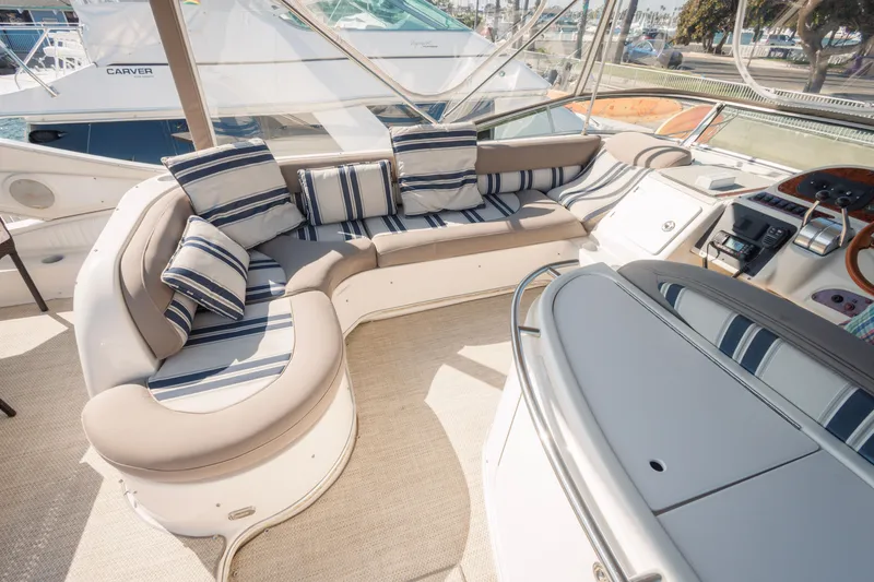 Slide: The Image of Luxurious seating area on a 1997 Maxum 4600 SCB yacht with striped cushions. - 48