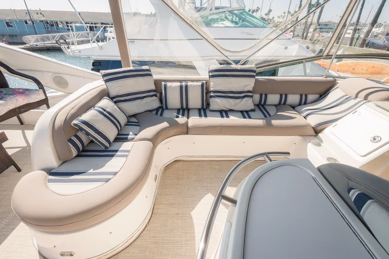 Slide: The Image of Luxurious seating area on a 1997 Maxum 4600 SCB yacht with striped cushions. - 49