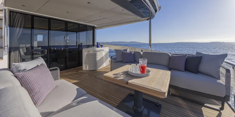 Slide: The Image of Luxurious 2025 Absolute NAVETTA 75 yacht deck with ocean view and comfortable seating. - 19