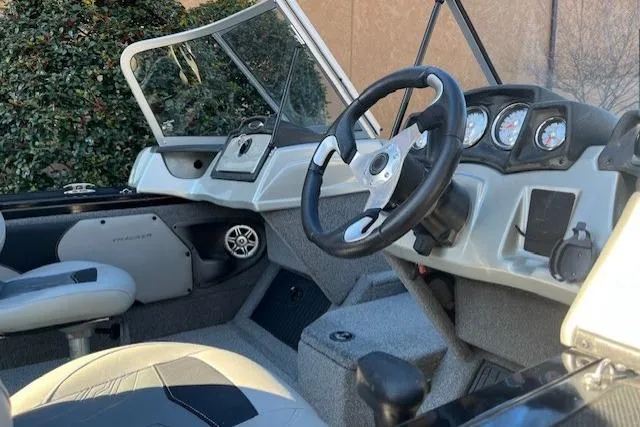 Slide: The Image of 2018 Tracker Targa 1900 boat interior with steering wheel and dashboard controls. - 14