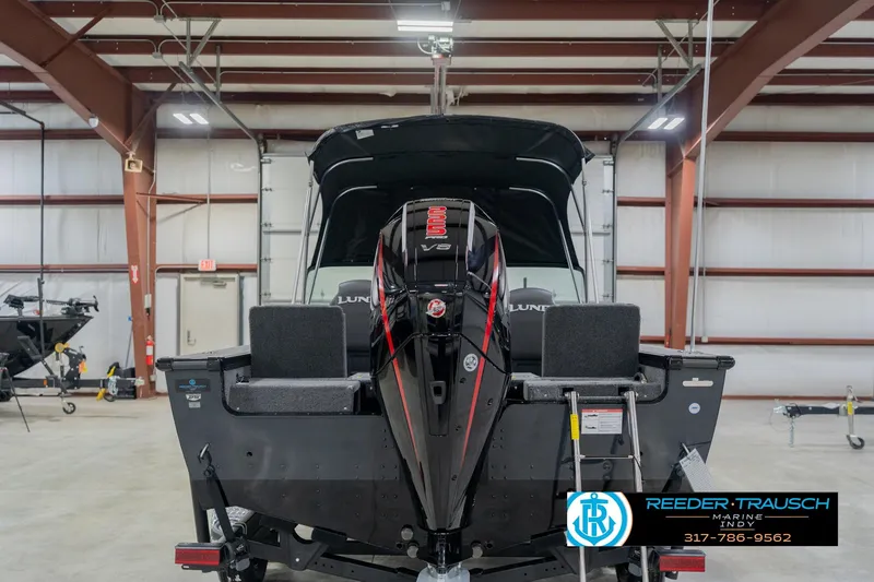 Slide: The Image of 2026 Lund 1975 Pro-V Sport boat in a showroom with outboard motor. - 10