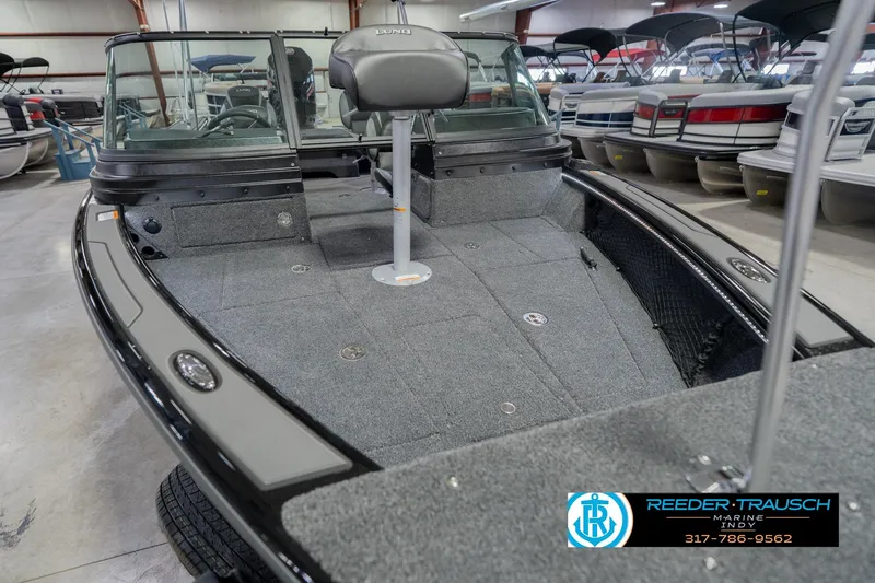 Slide: The Image of 2026 Lund 1975 Pro-V Sport boat interior with seating, displayed at Reeder-Trausch Marine showroom. - 14