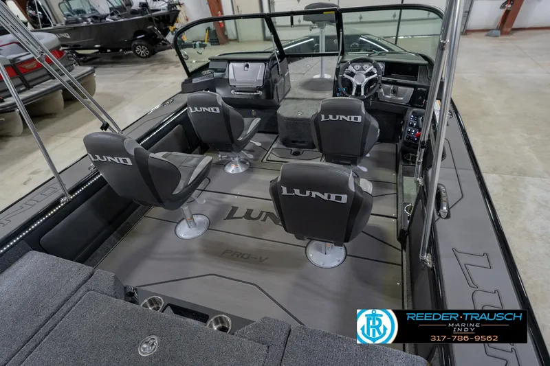 Slide: The Image of 2026 Lund 1975 Pro-V Sport boat interior with four seats and steering console. - 15