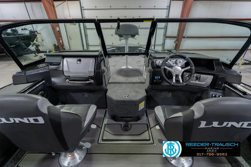 Slide: The Image of Interior of 2026 Lund 1975 Pro-V Sport boat with steering wheel and seating. - 18