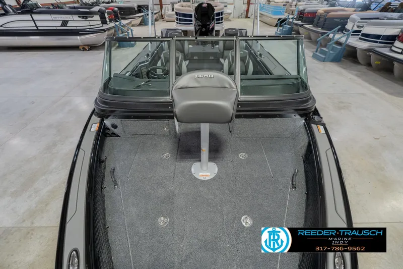 Slide: The Image of 2026 Lund 1975 Pro-V Sport boat interior with seating, displayed at Reeder-Trausch Marine showroom. - 20