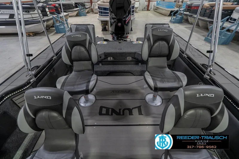Slide: The Image of 2026 Lund 1975 Pro-V Sport boat interior with four gray seats in a showroom. - 21