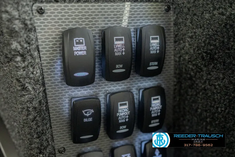 Slide: The Image of Control panel of 2026 Lund 1975 Pro-V Sport boat with various switches. - 41