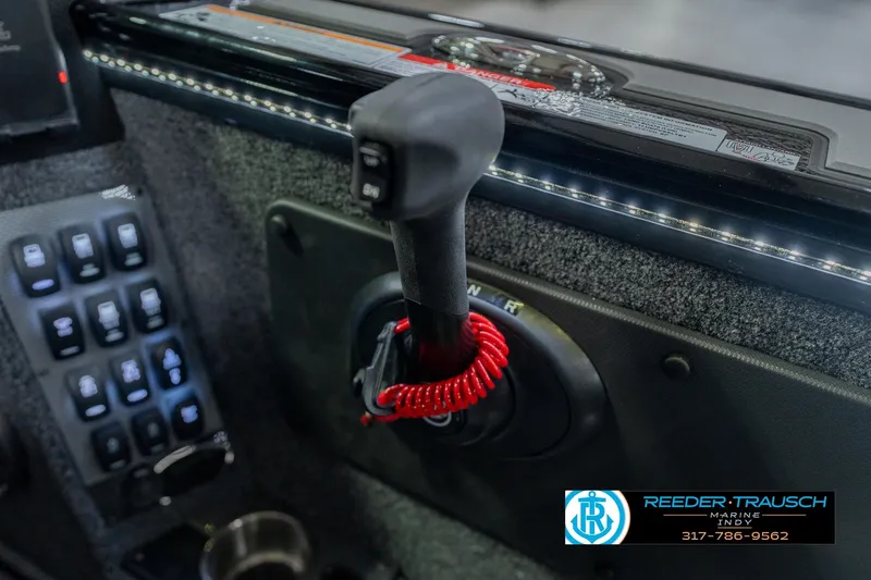 Slide: The Image of Control panel of 2026 Lund 1975 Pro-V Sport boat with throttle and switches. - 43