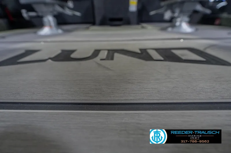 Slide: The Image of 2026 Lund 1975 Pro-V Sport boat deck with logo, Reeder Trausch Marine contact details. - 51