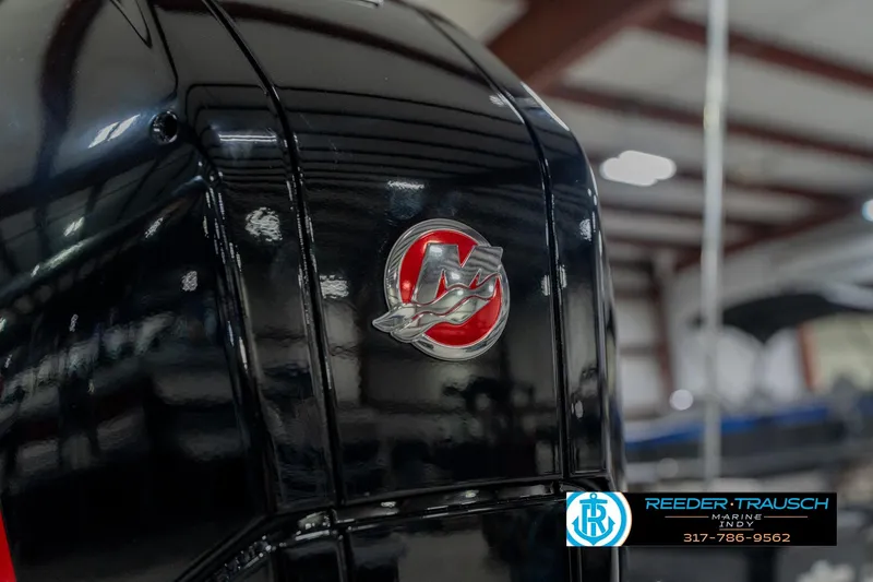 Slide: The Image of 2026 Lund 1975 Pro-V Sport boat engine with logo in a showroom setting. - 55